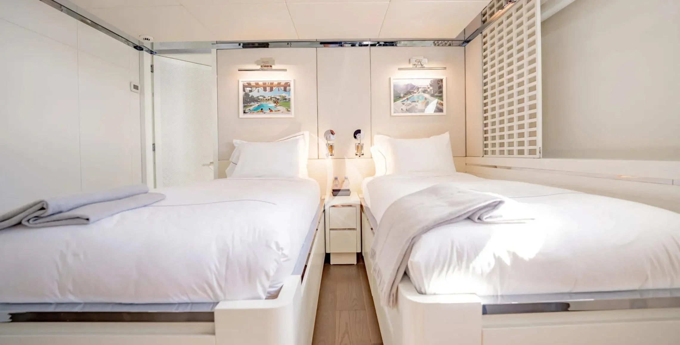 a room with white beds aboard BG Yacht for Sale