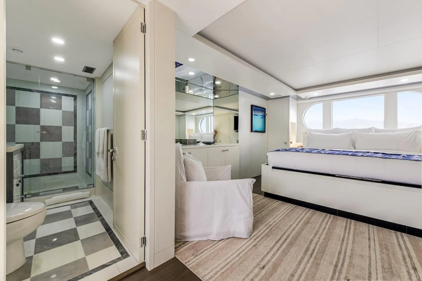 a bedroom with a bed and a mirror aboard BG Yacht for Sale