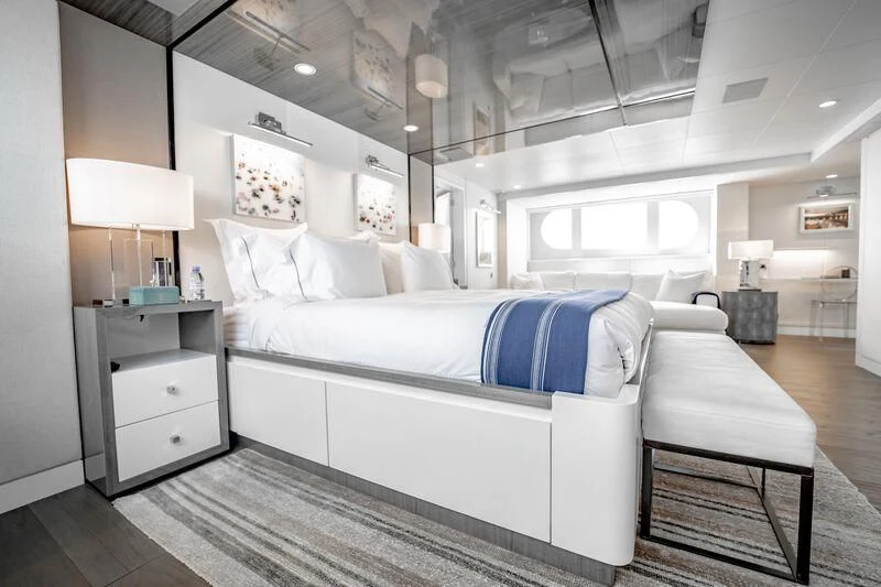 a bedroom with a bed and a desk aboard BG Yacht for Sale