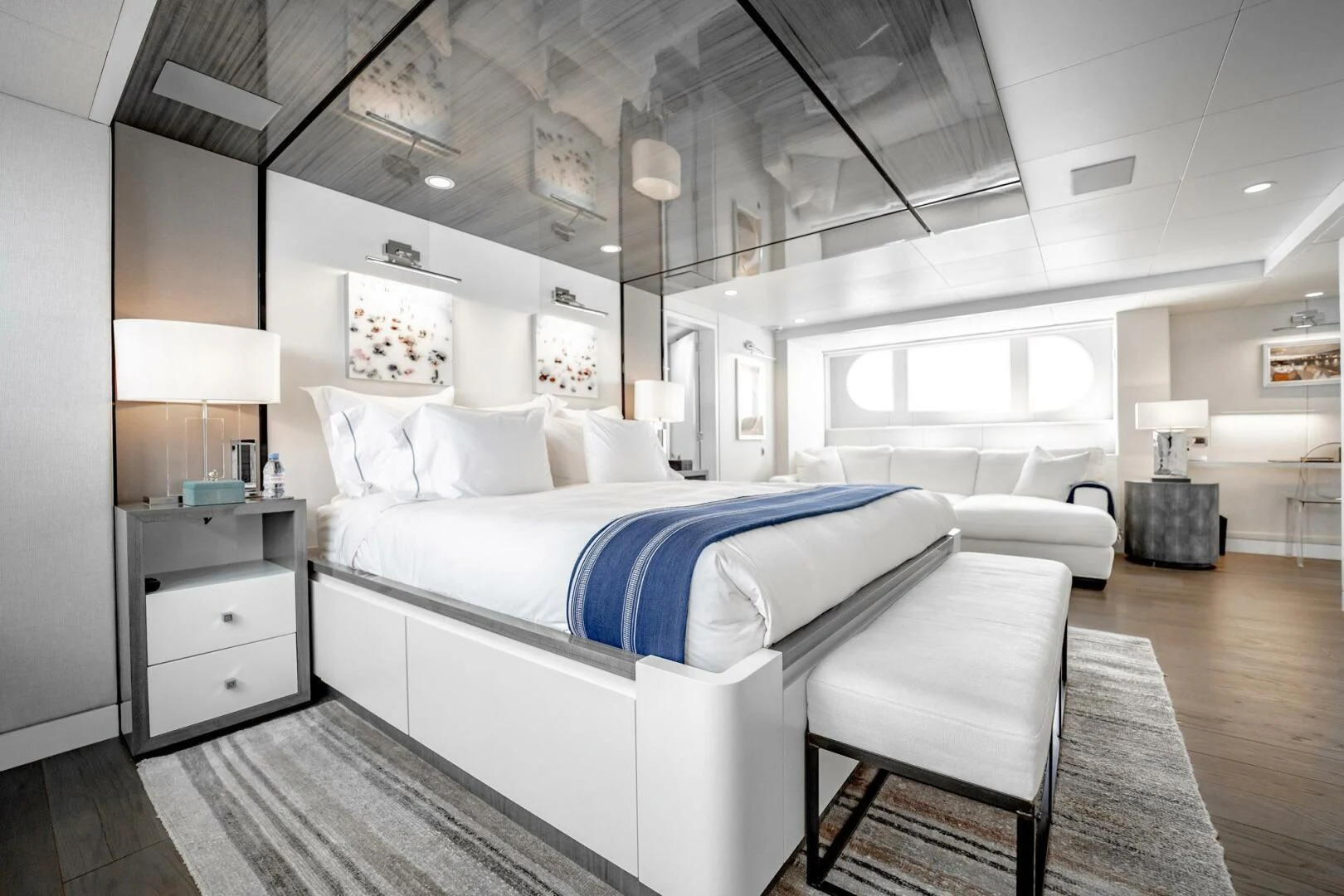 a room with a bed and a chair aboard BG Yacht for Sale