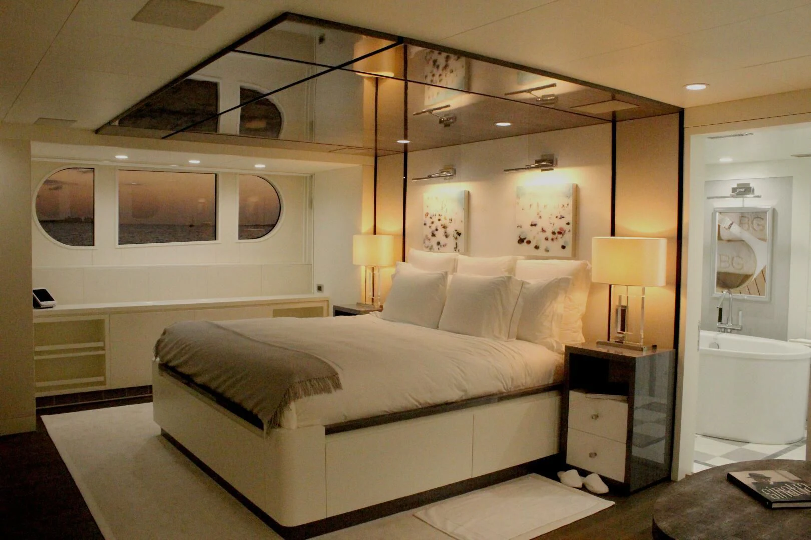 a bedroom with a bed and a desk aboard BG Yacht for Sale