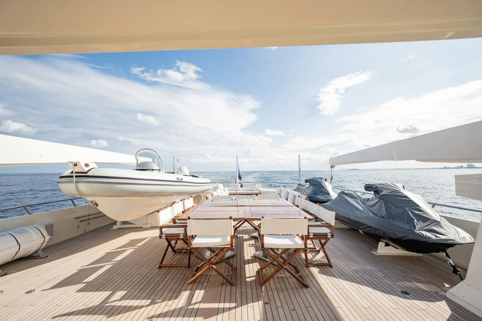 a deck with a couple of boats on it and a large boat in the background aboard BG Yacht for Sale