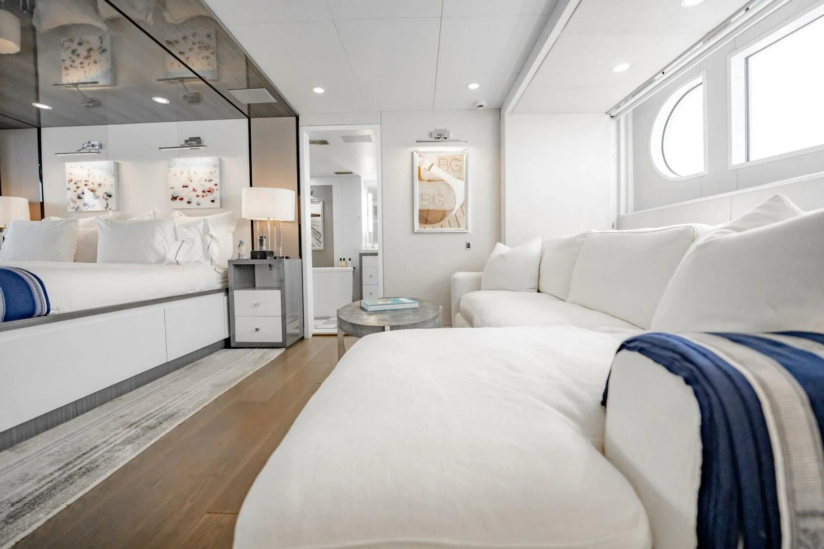 a room with white couches aboard BG Yacht for Sale