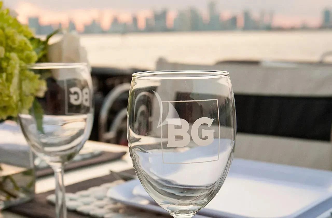 a couple of glasses of wine on a table aboard BG Yacht for Sale