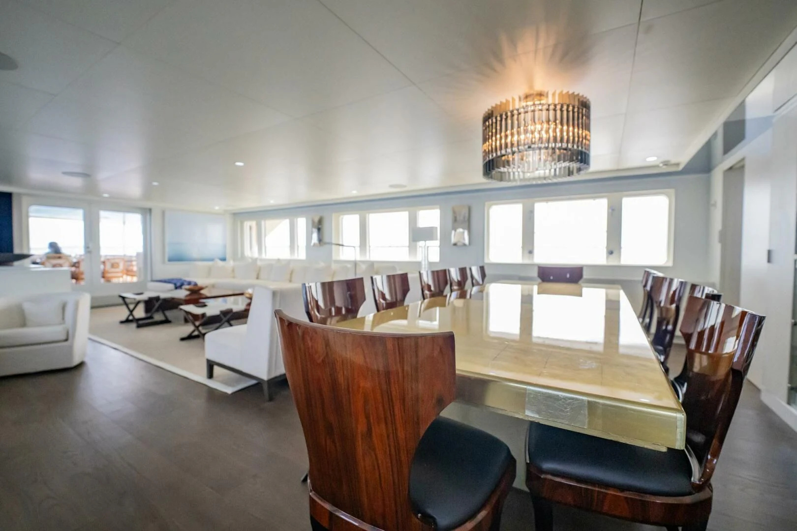 a large dining room with a large chandelier aboard BG Yacht for Sale
