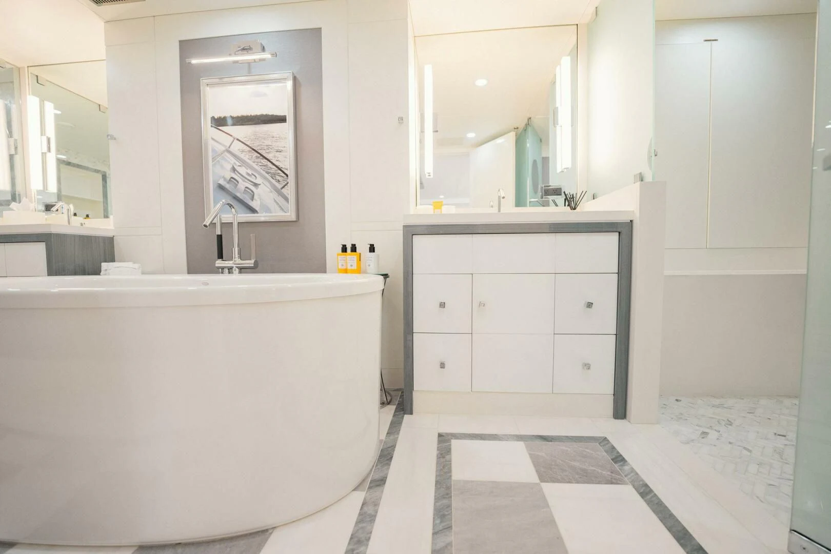 a bathroom with a tub sink and cabinets aboard BG Yacht for Sale