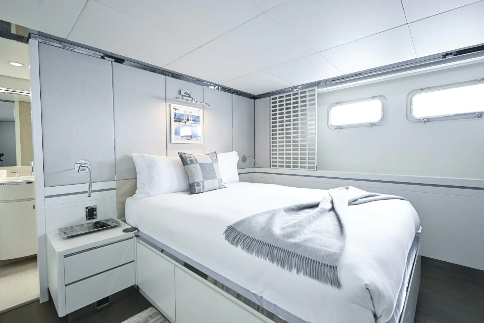 a white bedroom with a bed aboard BG Yacht for Sale