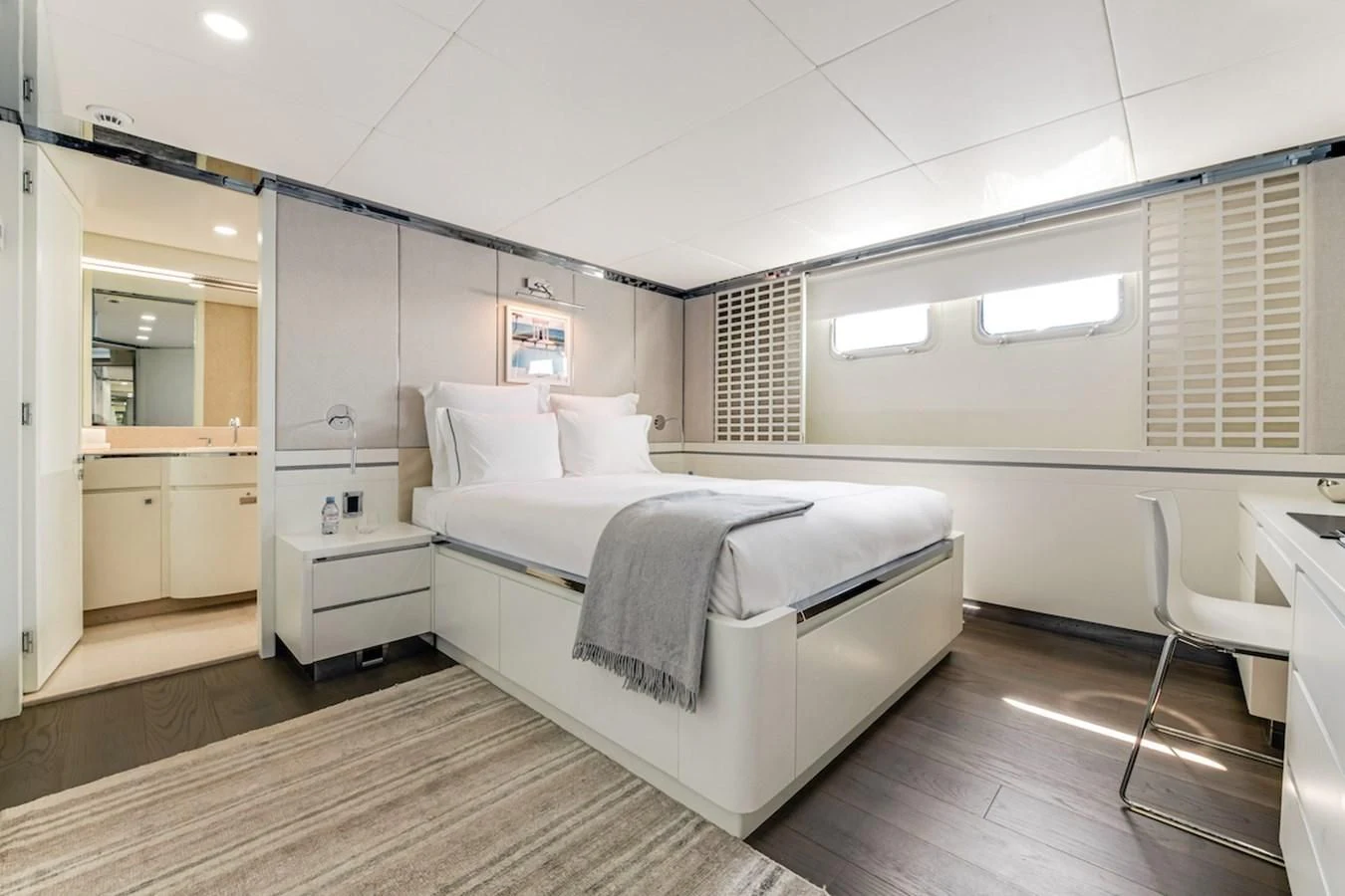 a bedroom with a bed and a desk aboard BG Yacht for Sale