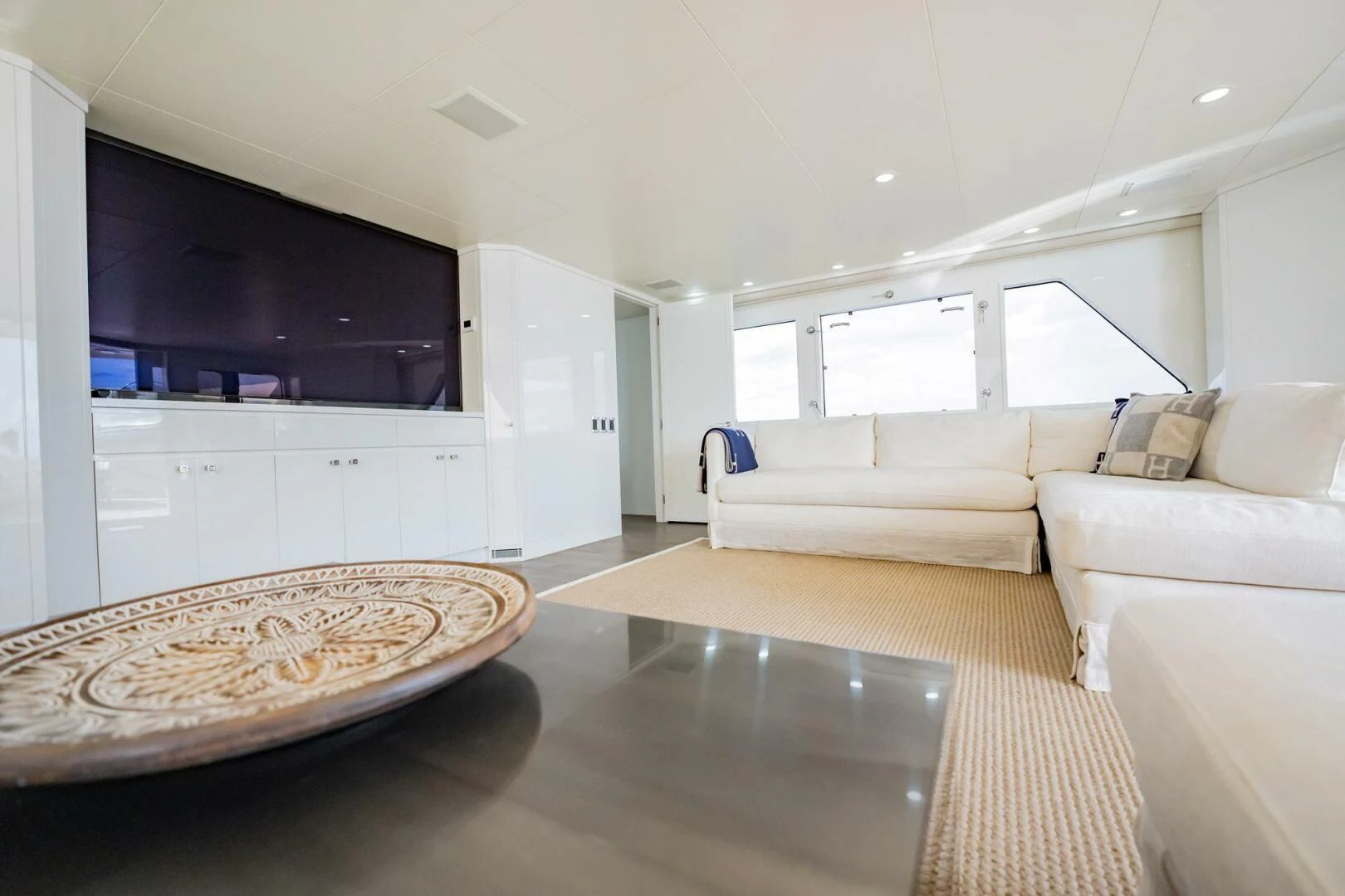 a large living room with a large tv and a large rug aboard BG Yacht for Sale