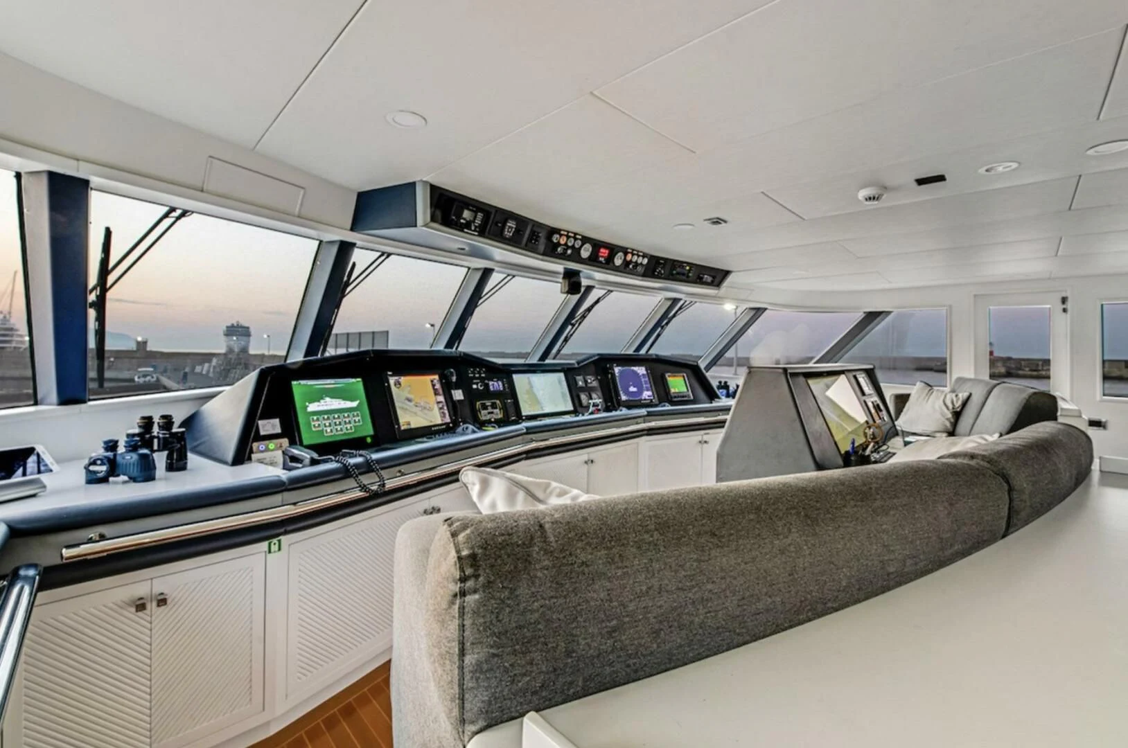 a room with a couch and a computer on the desk aboard BG Yacht for Sale