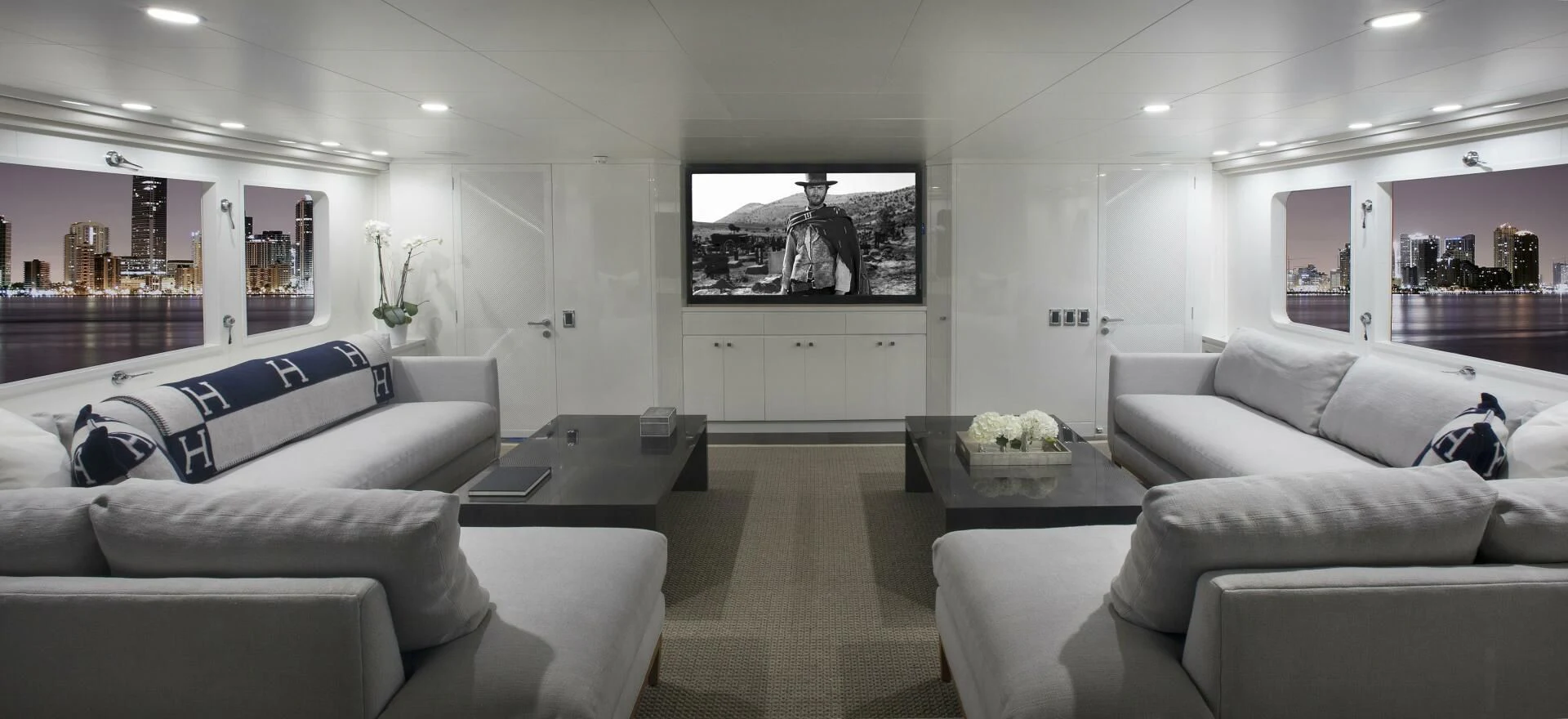 a living room with white couches aboard BG Yacht for Sale