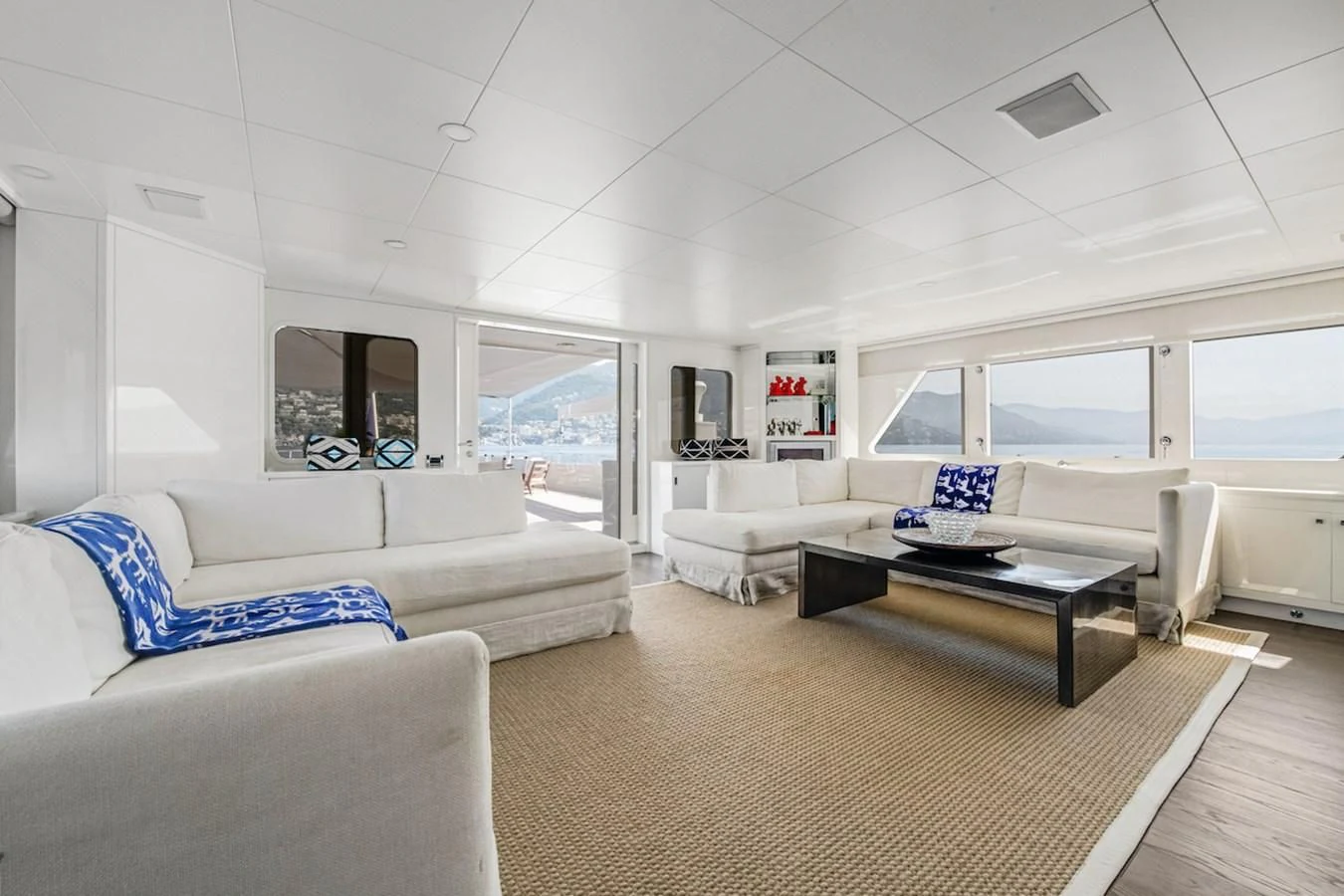 a living room with white furniture aboard BG Yacht for Sale