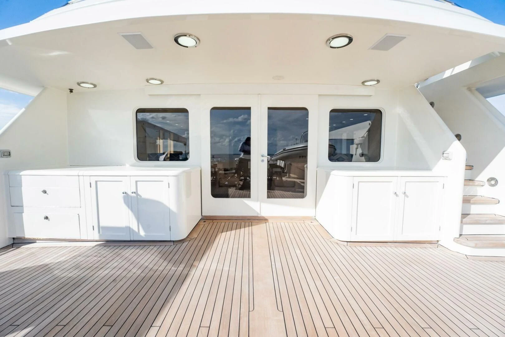a white room with a wood floor aboard BG Yacht for Sale