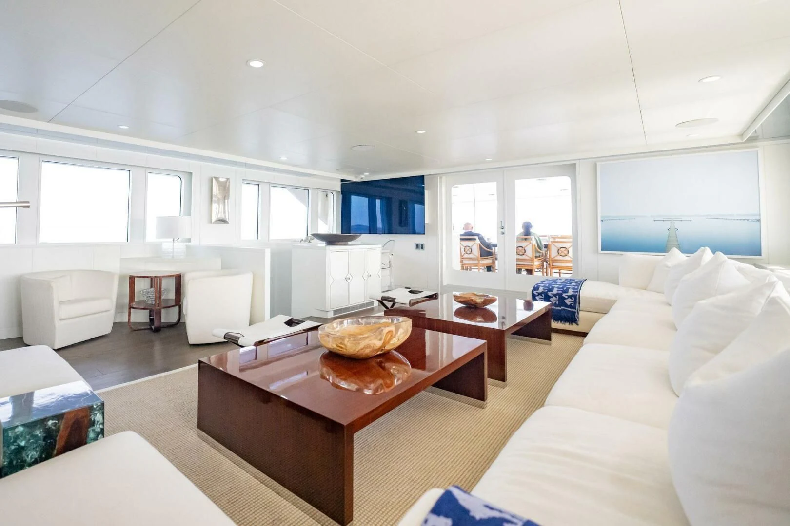 a living room with a table and couches aboard BG Yacht for Sale