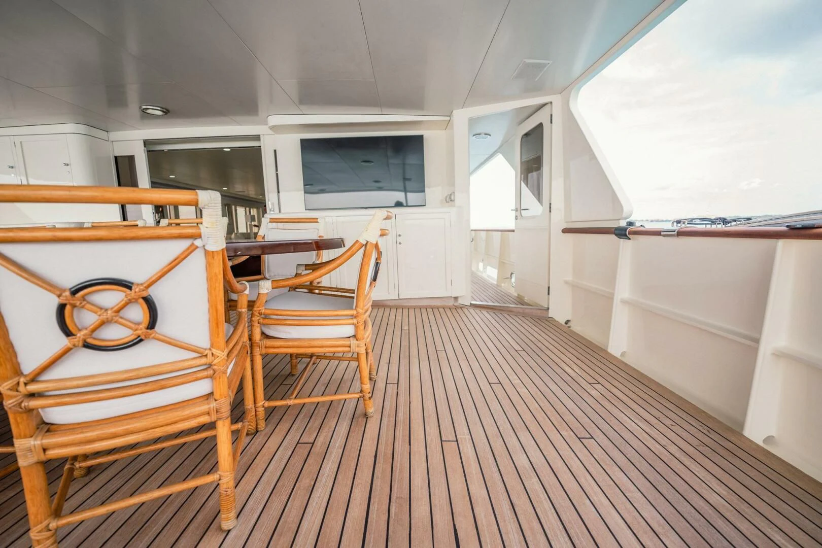 a room with a wood floor and a chair and a table aboard BG Yacht for Sale