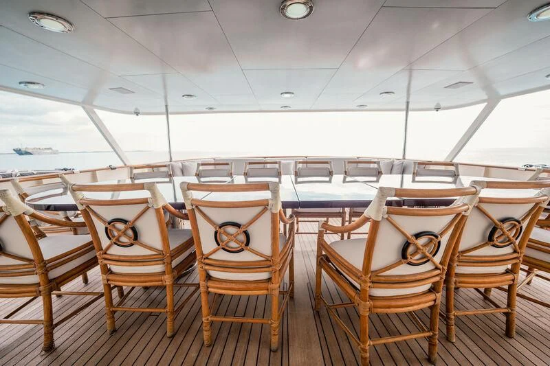 a room with chairs and tables aboard BG Yacht for Sale