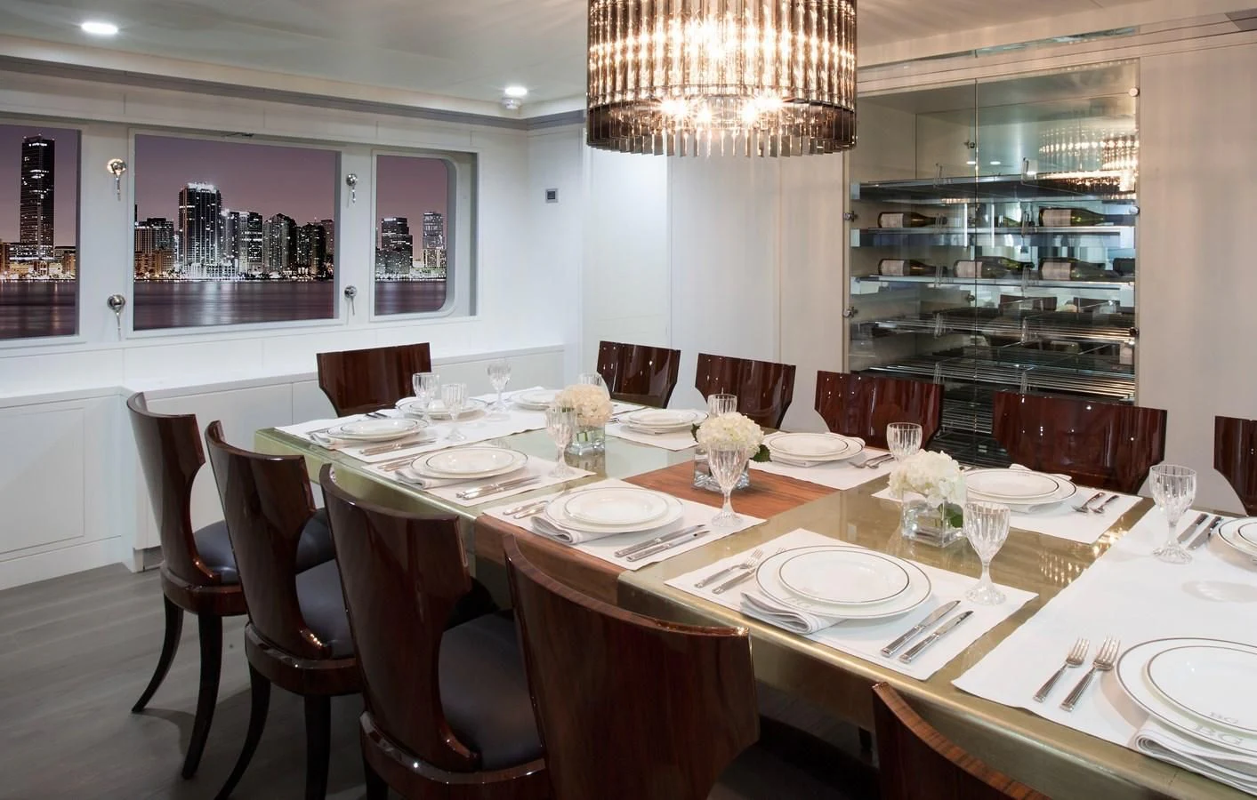 a table set with plates and glasses aboard BG Yacht for Sale