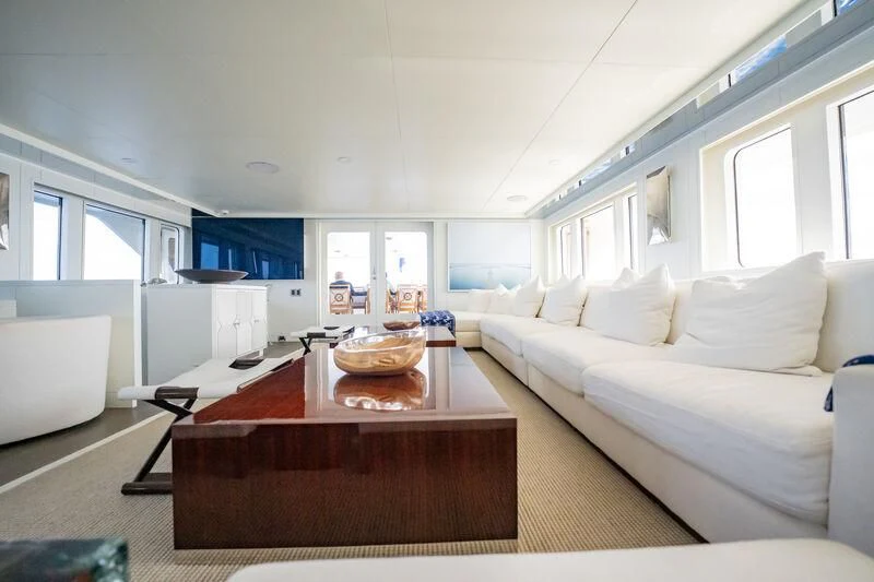 a living room with a white couch and a table aboard BG Yacht for Sale