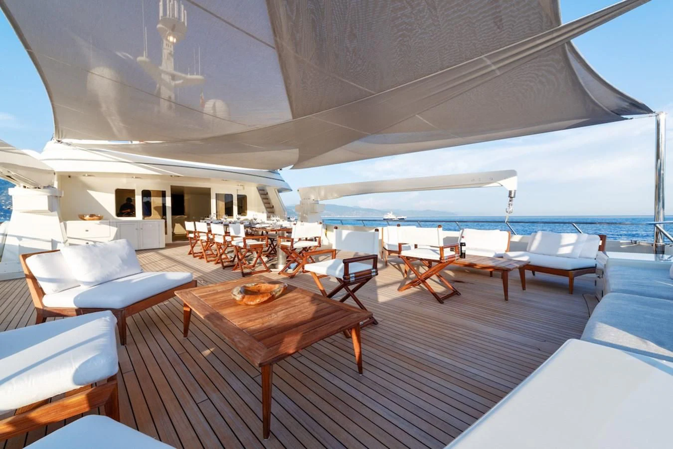 a room with tables and chairs aboard BG Yacht for Sale