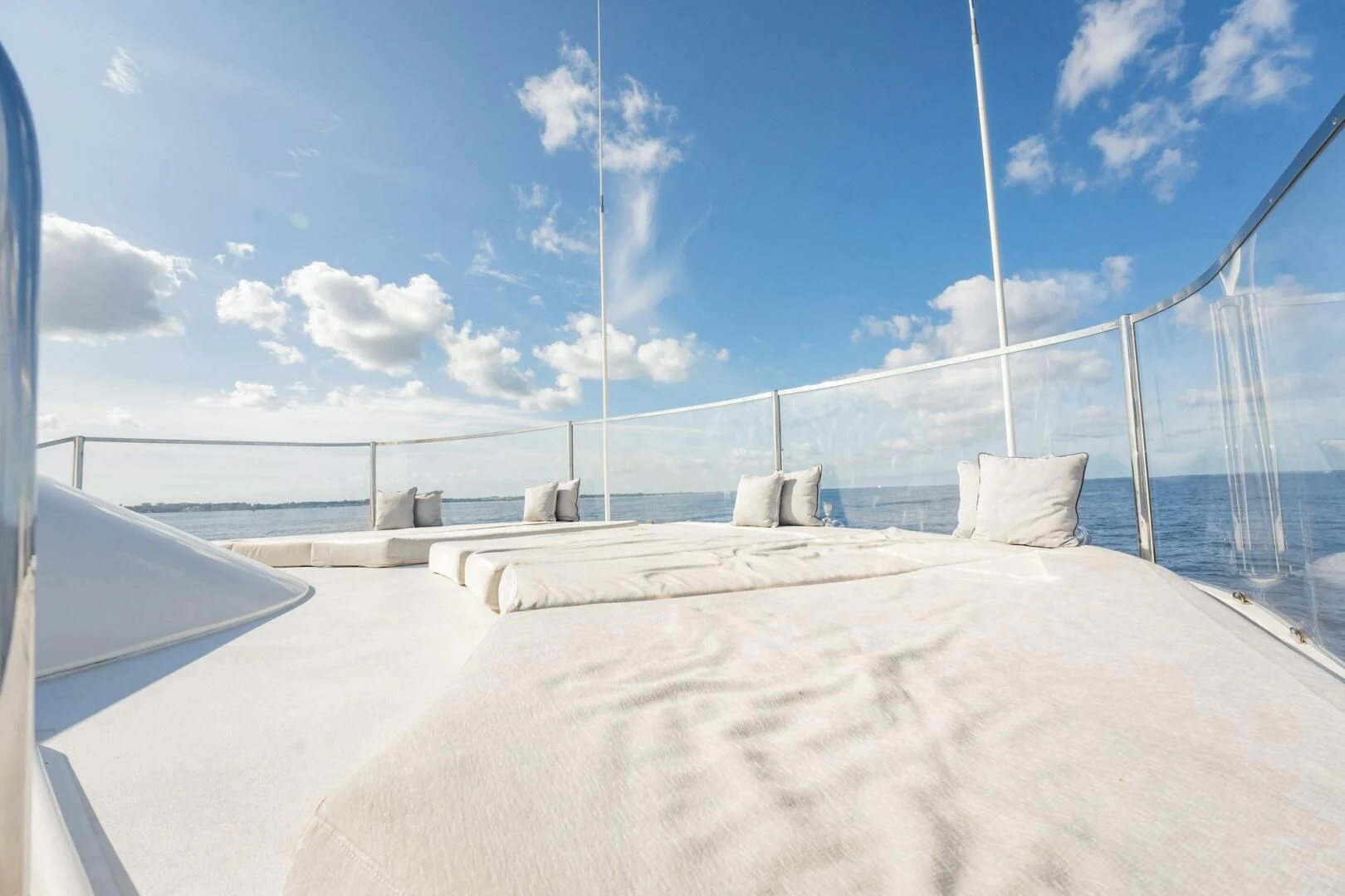 a large white sand beach with a white sand beach and blue sky aboard BG Yacht for Sale