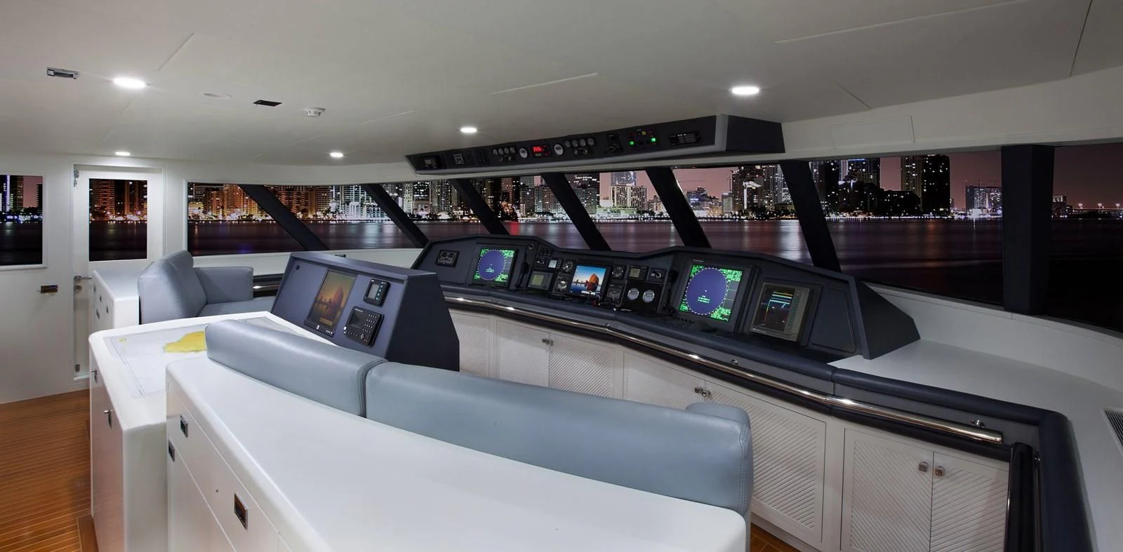 a room with a large white counter and a large window with screens aboard BG Yacht for Sale