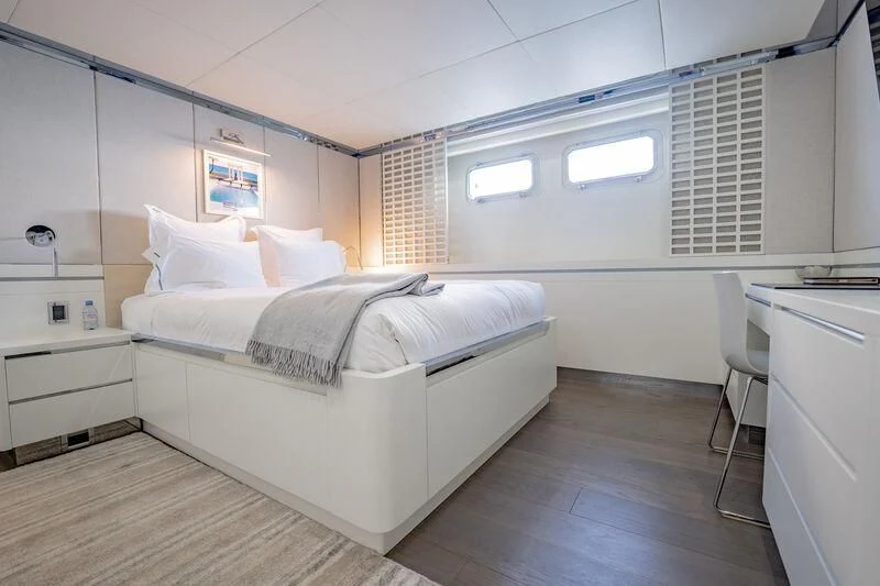 a room with a bed and a desk aboard BG Yacht for Sale