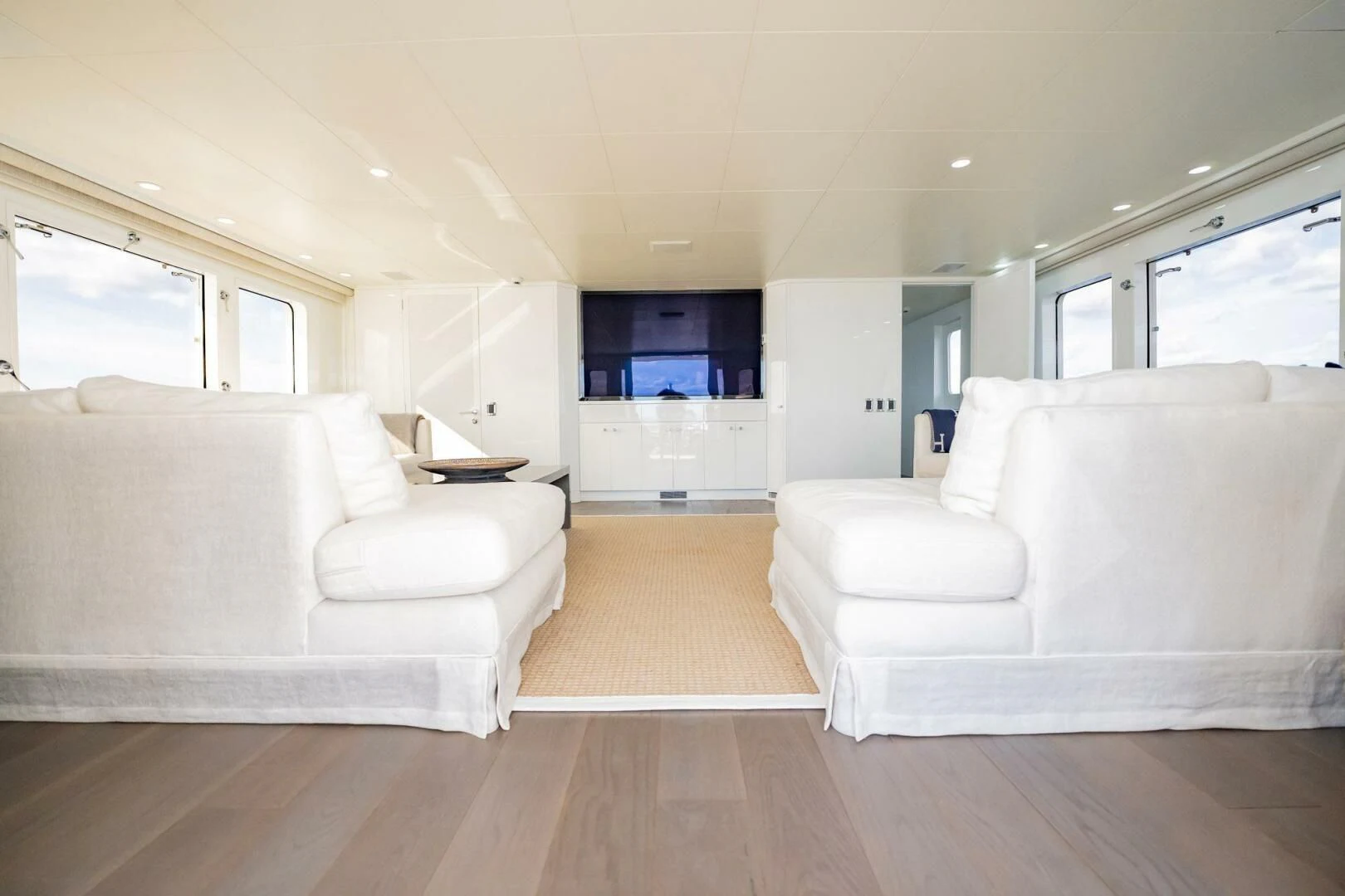 a living room with white couches aboard BG Yacht for Sale