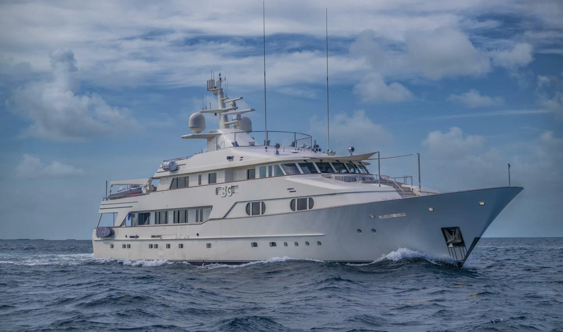 a white boat in the water aboard BG Yacht for Sale