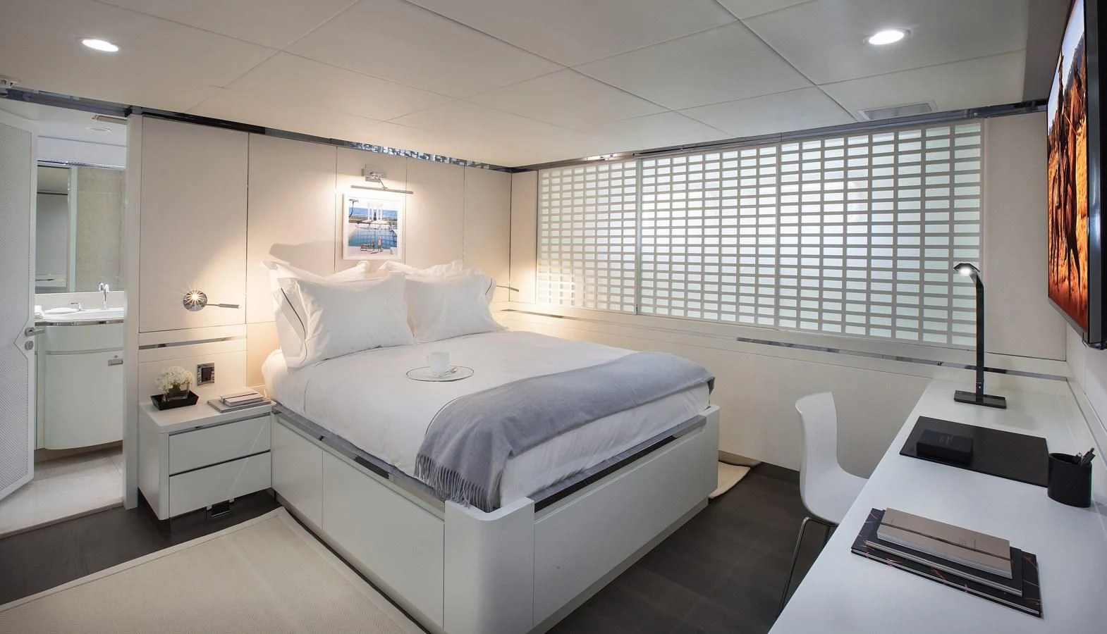 a bedroom with a bed and a desk aboard BG Yacht for Sale