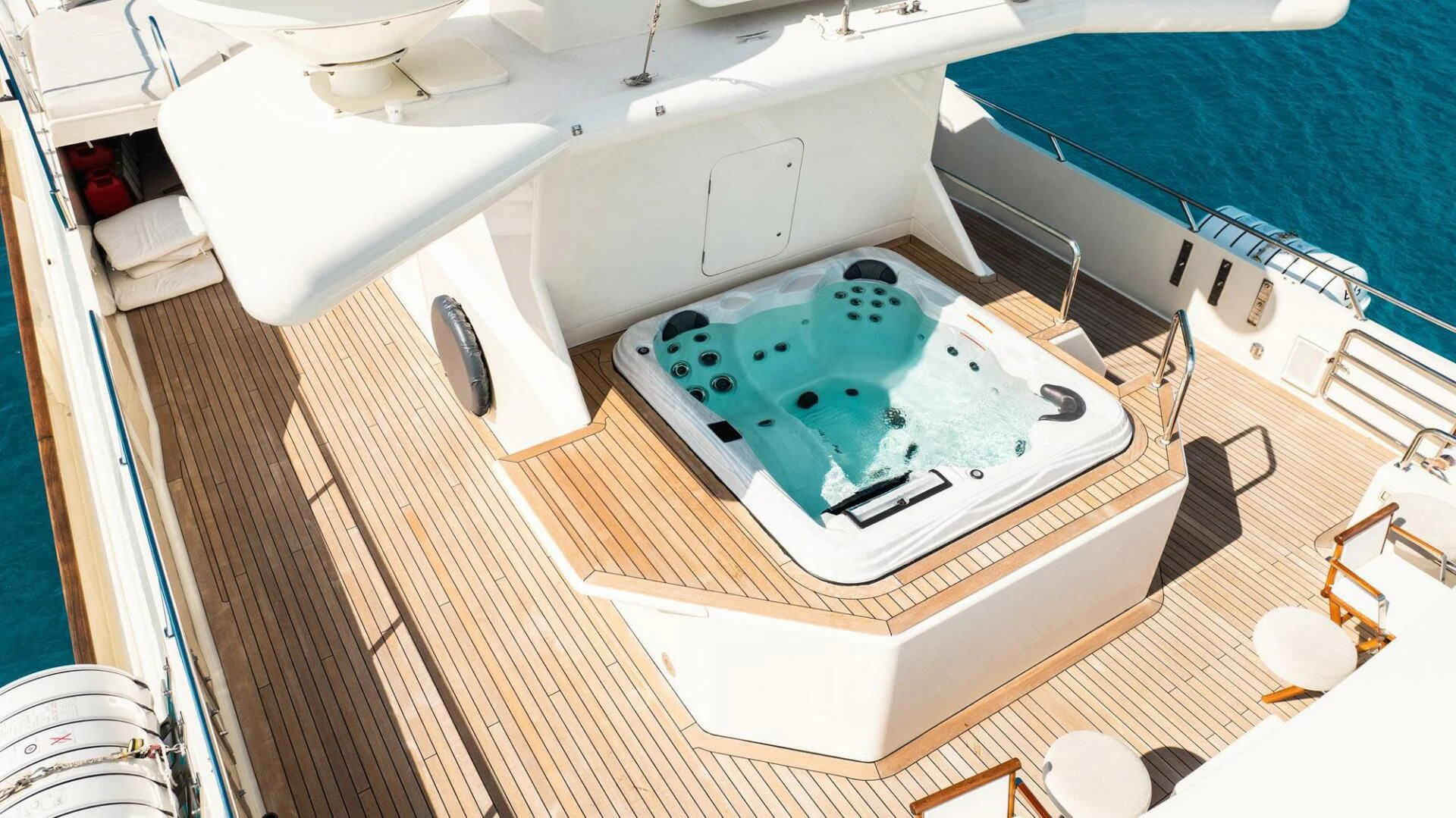 a bathtub with a sink and a bed in the background aboard BG Yacht for Sale