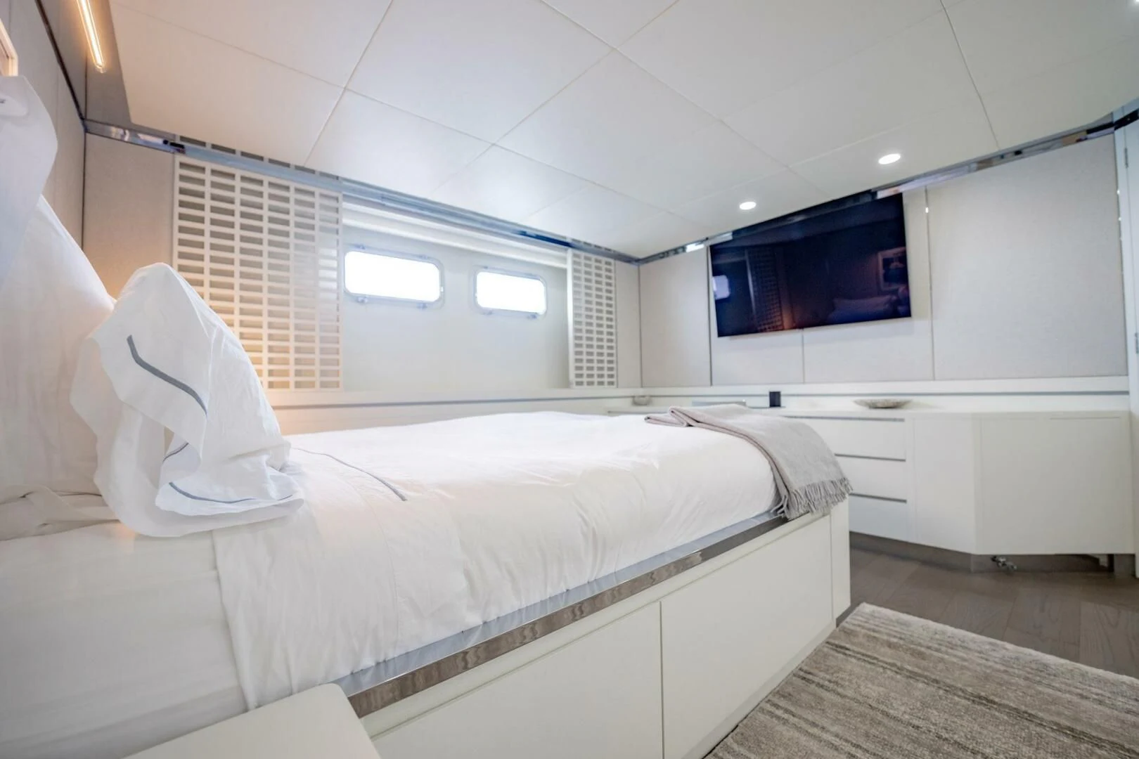 a room with a bed and a television aboard BG Yacht for Sale