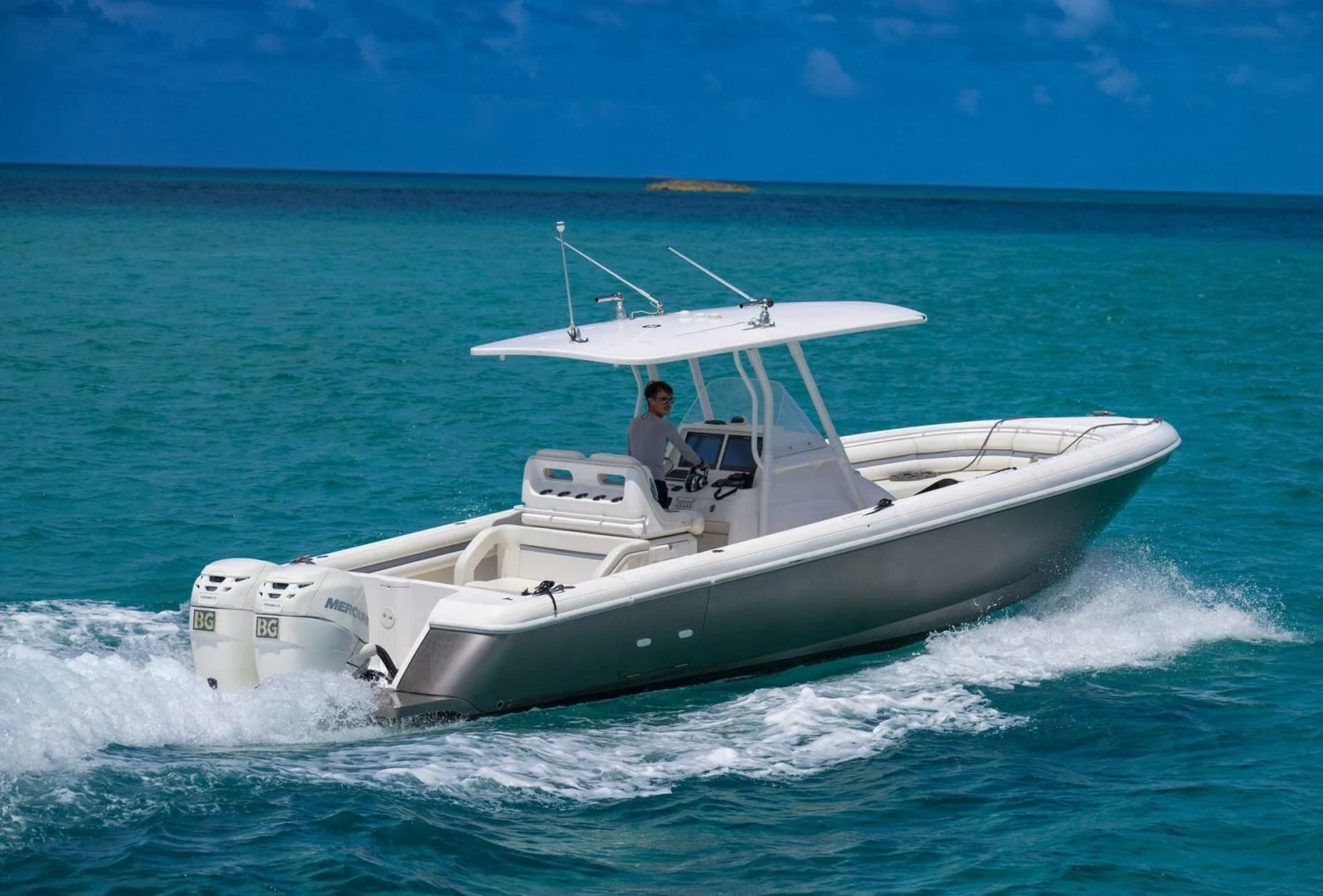 a person driving a boat on the water aboard BG Yacht for Sale