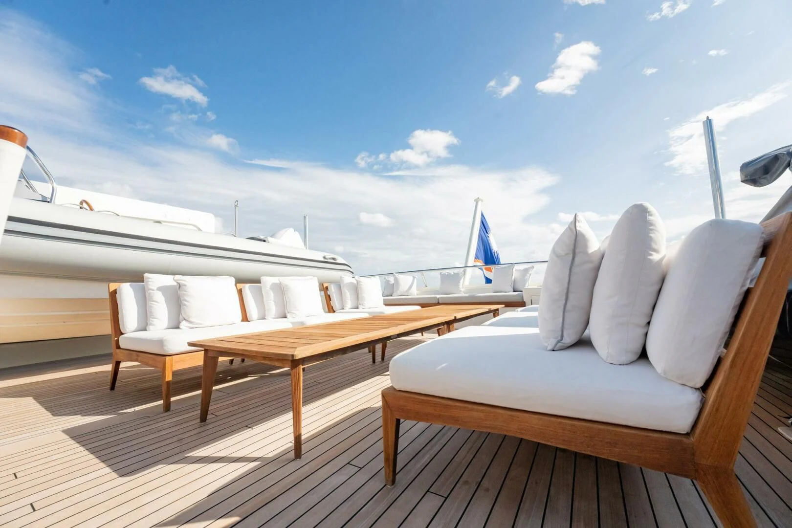 a deck with chairs and a table on it aboard BG Yacht for Sale