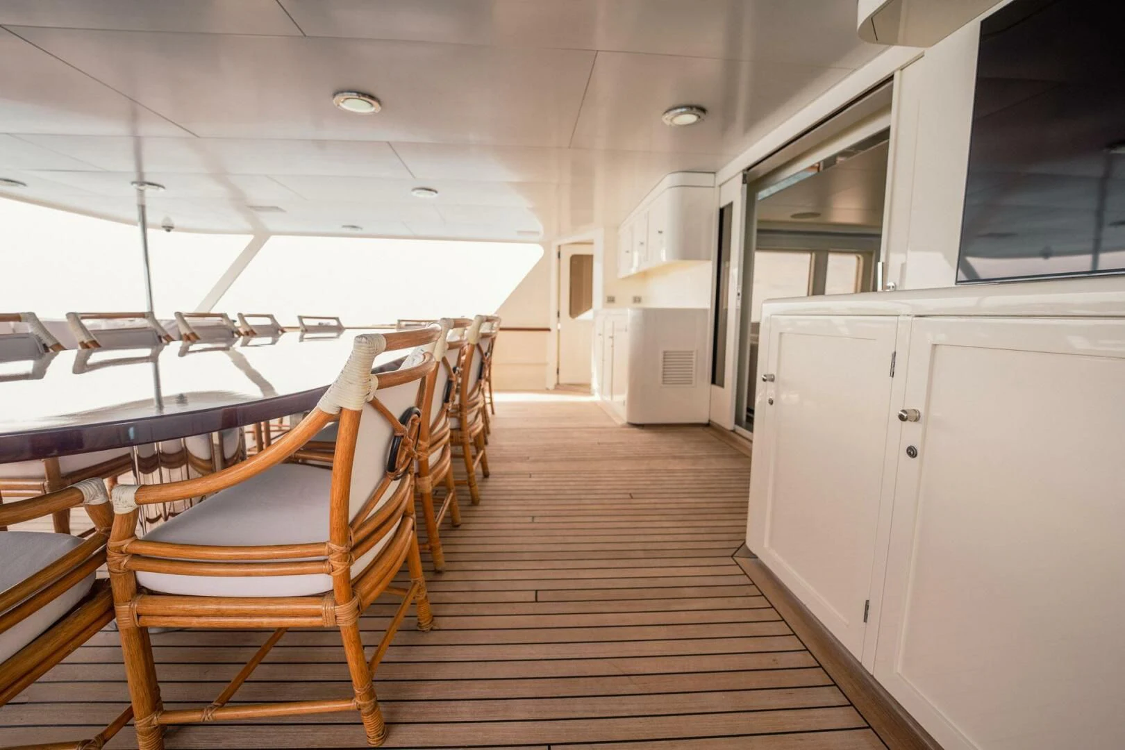 a room with a wood floor and chairs aboard BG Yacht for Sale