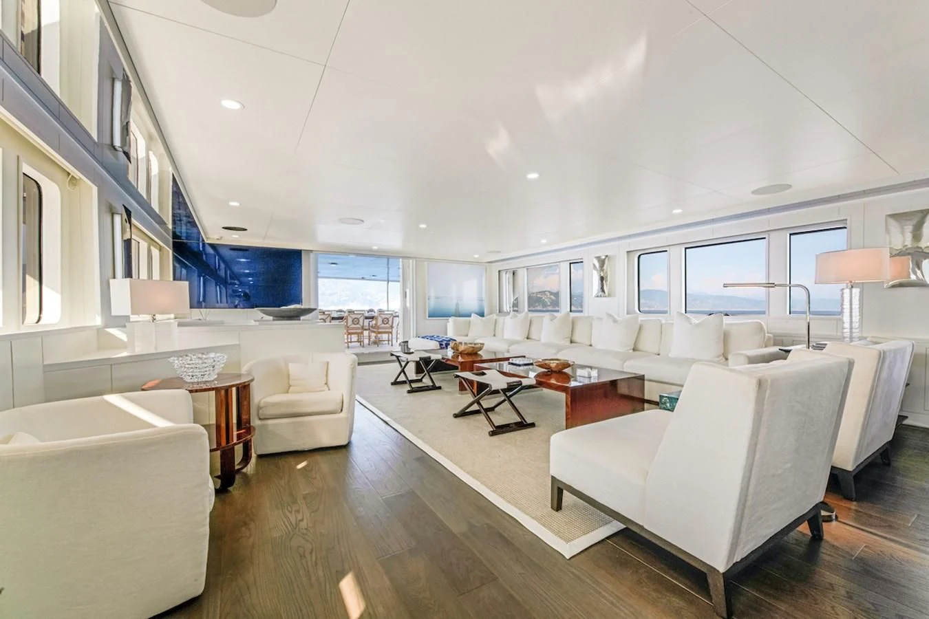 a living room with a large white couch and a large window aboard BG Yacht for Sale