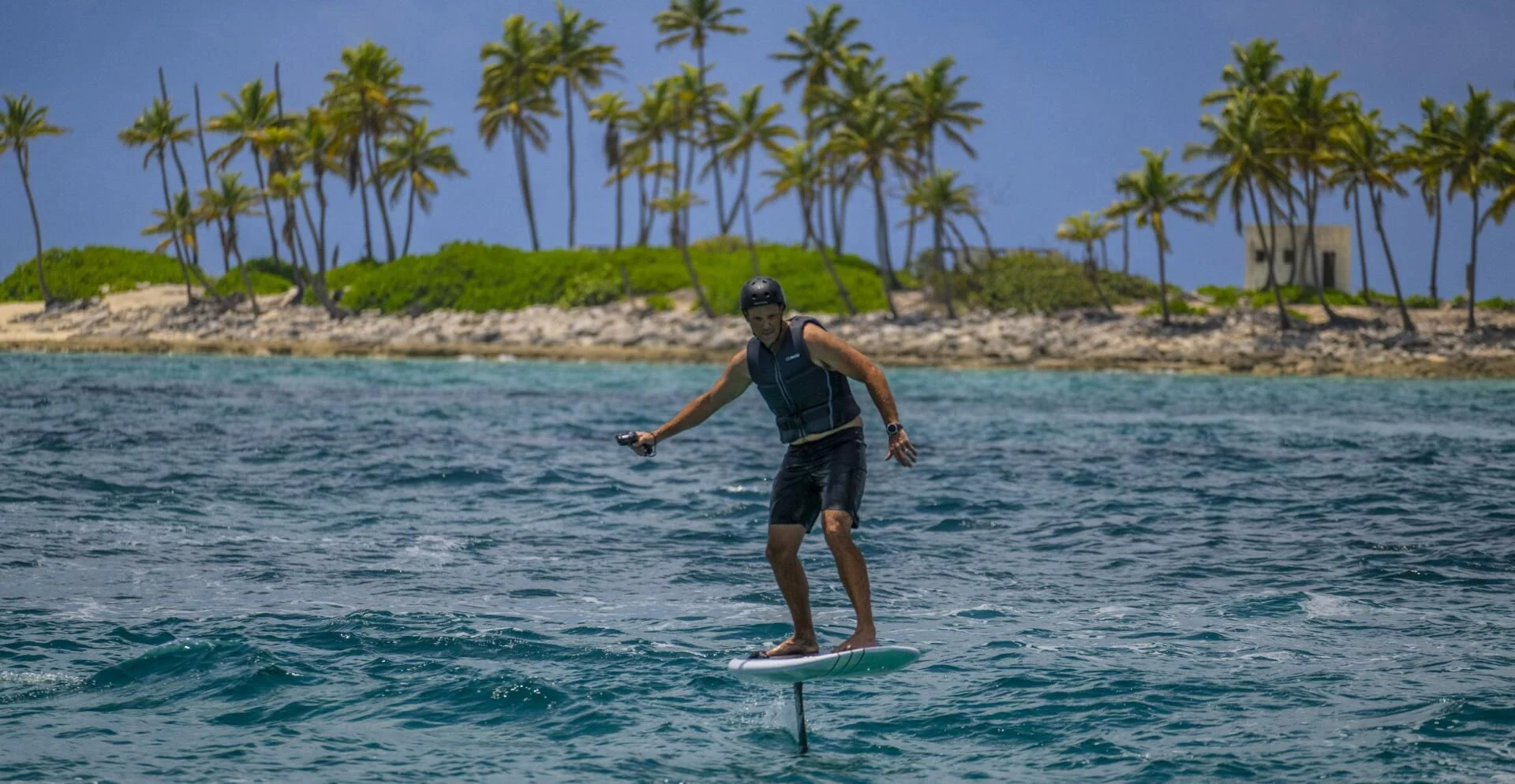 a man riding a surfboard aboard BG Yacht for Sale
