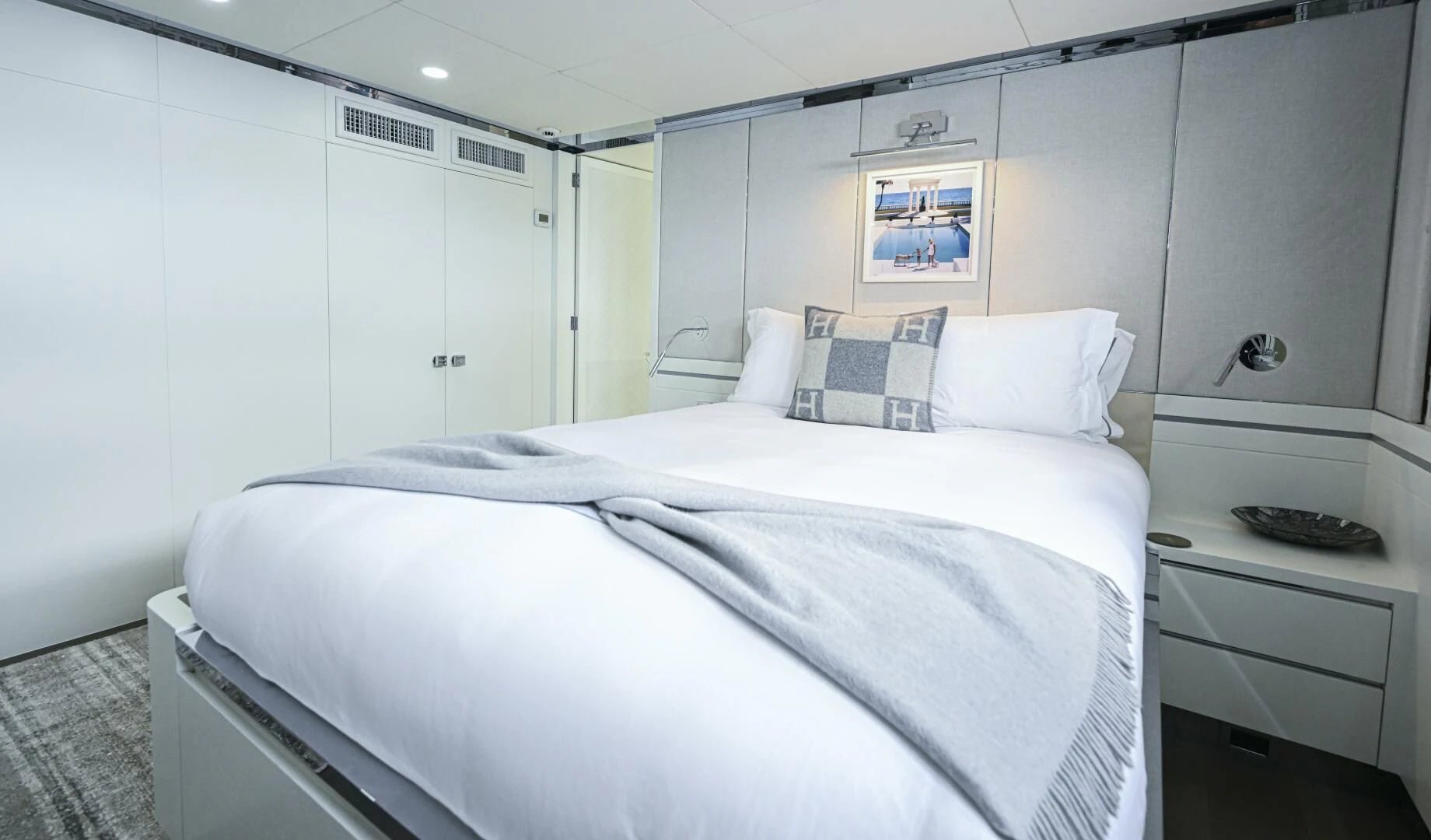 a white bedroom with a bed aboard BG Yacht for Sale