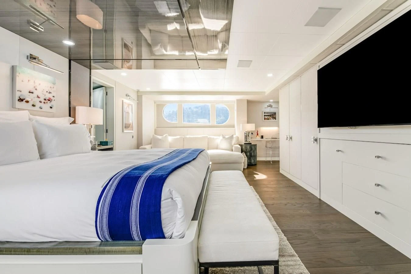 a bedroom with a bed and a tv on the wall aboard BG Yacht for Sale
