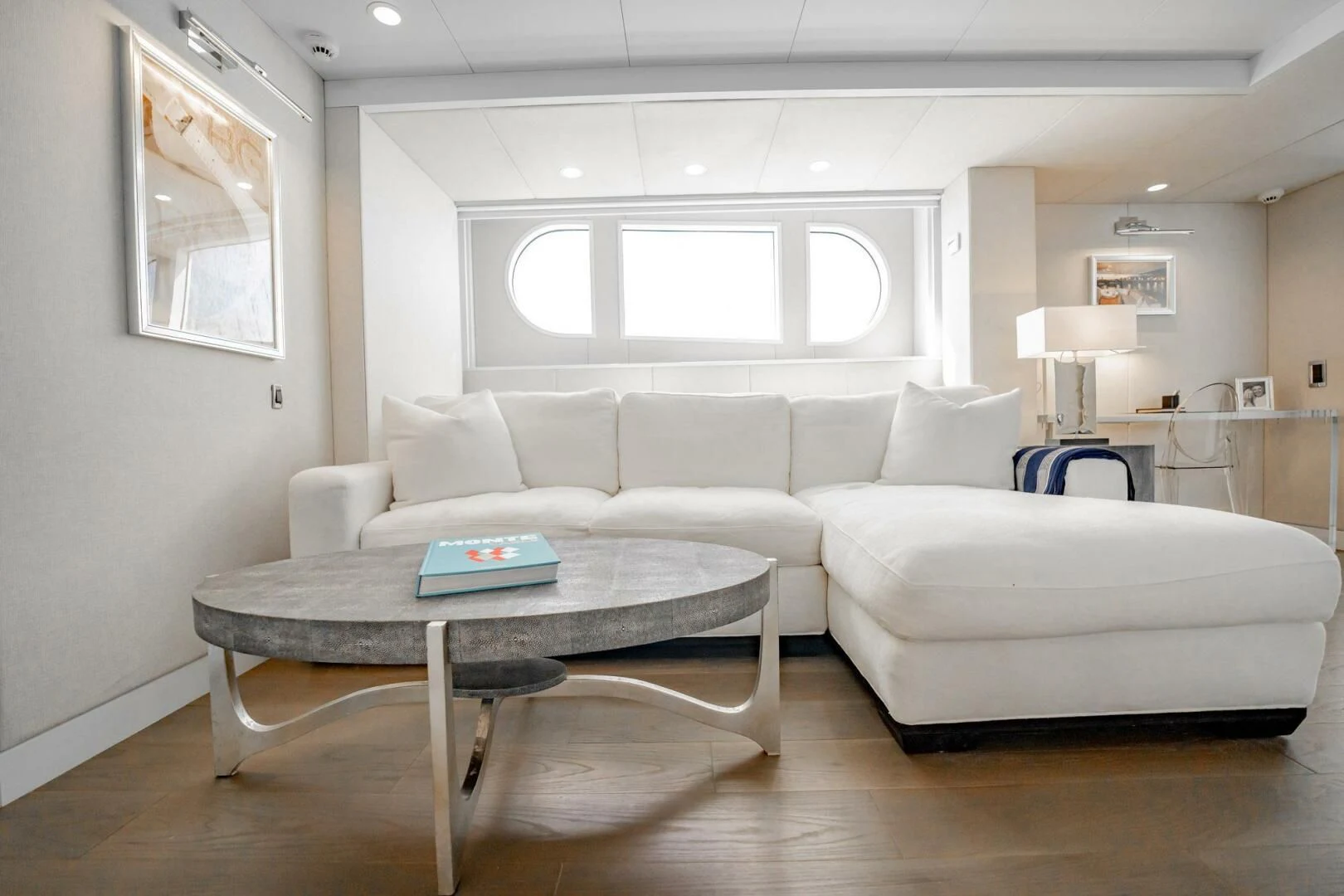 a living room with a white couch aboard BG Yacht for Sale