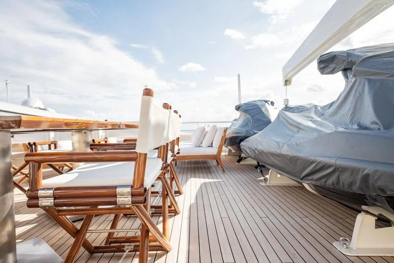a deck with chairs and a boat on it aboard BG Yacht for Sale