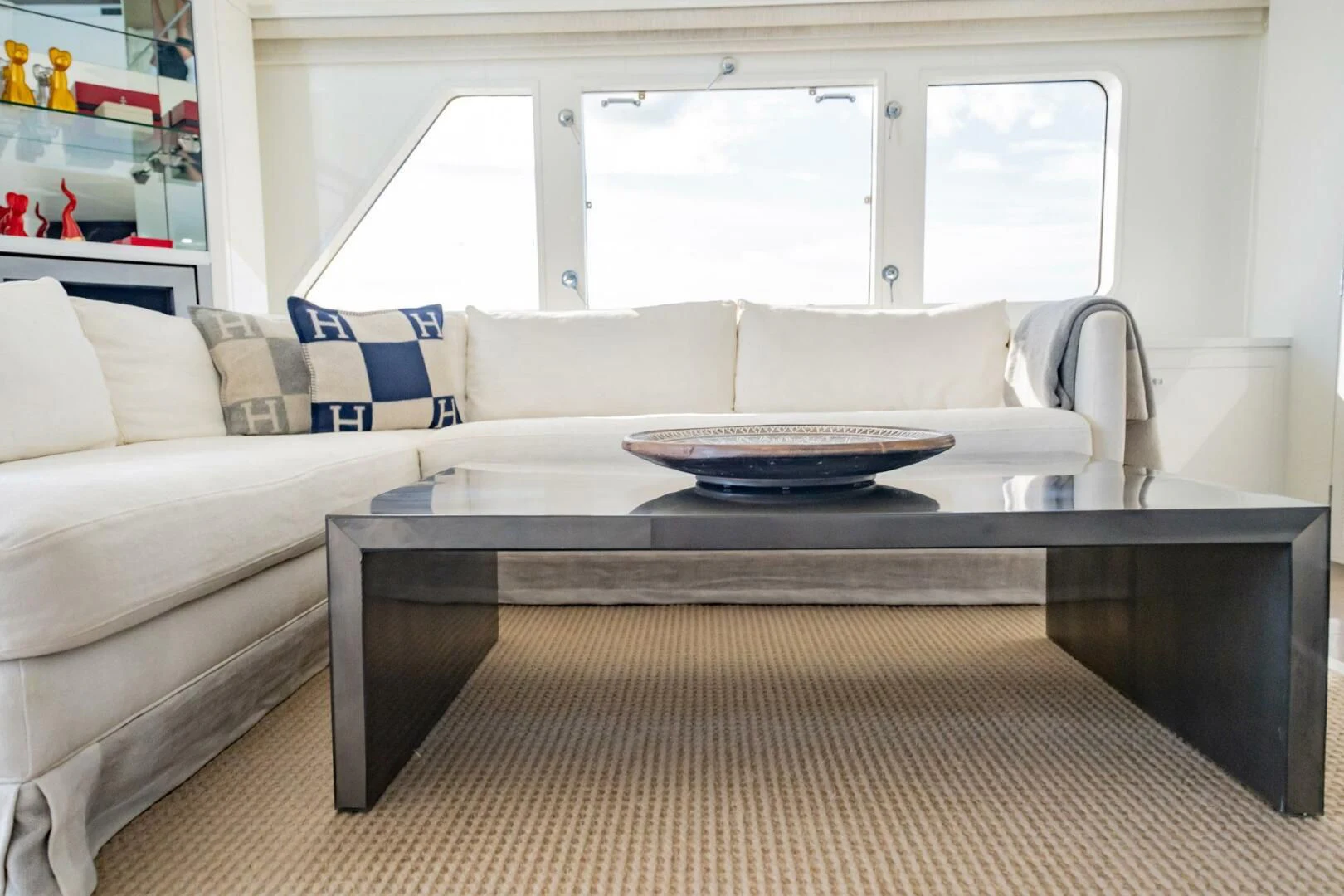 a white couch with a round table aboard BG Yacht for Sale