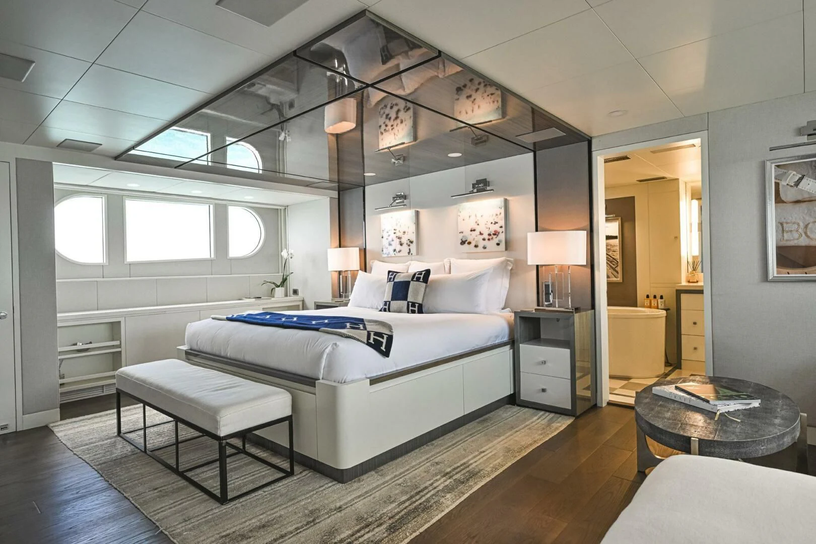 a bedroom with a bed and a table aboard BG Yacht for Sale