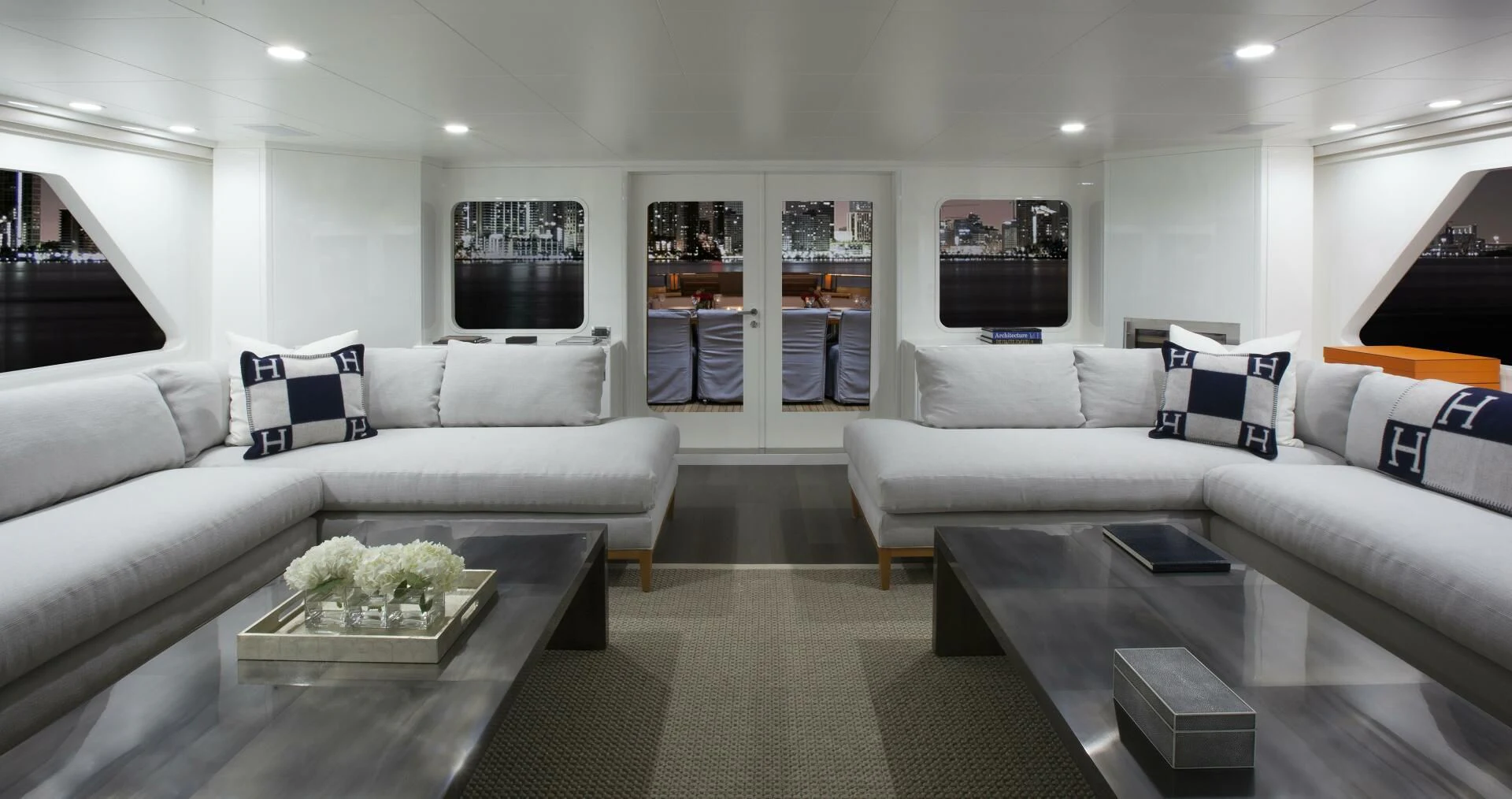 a living room with a white couch and a coffee table aboard BG Yacht for Sale