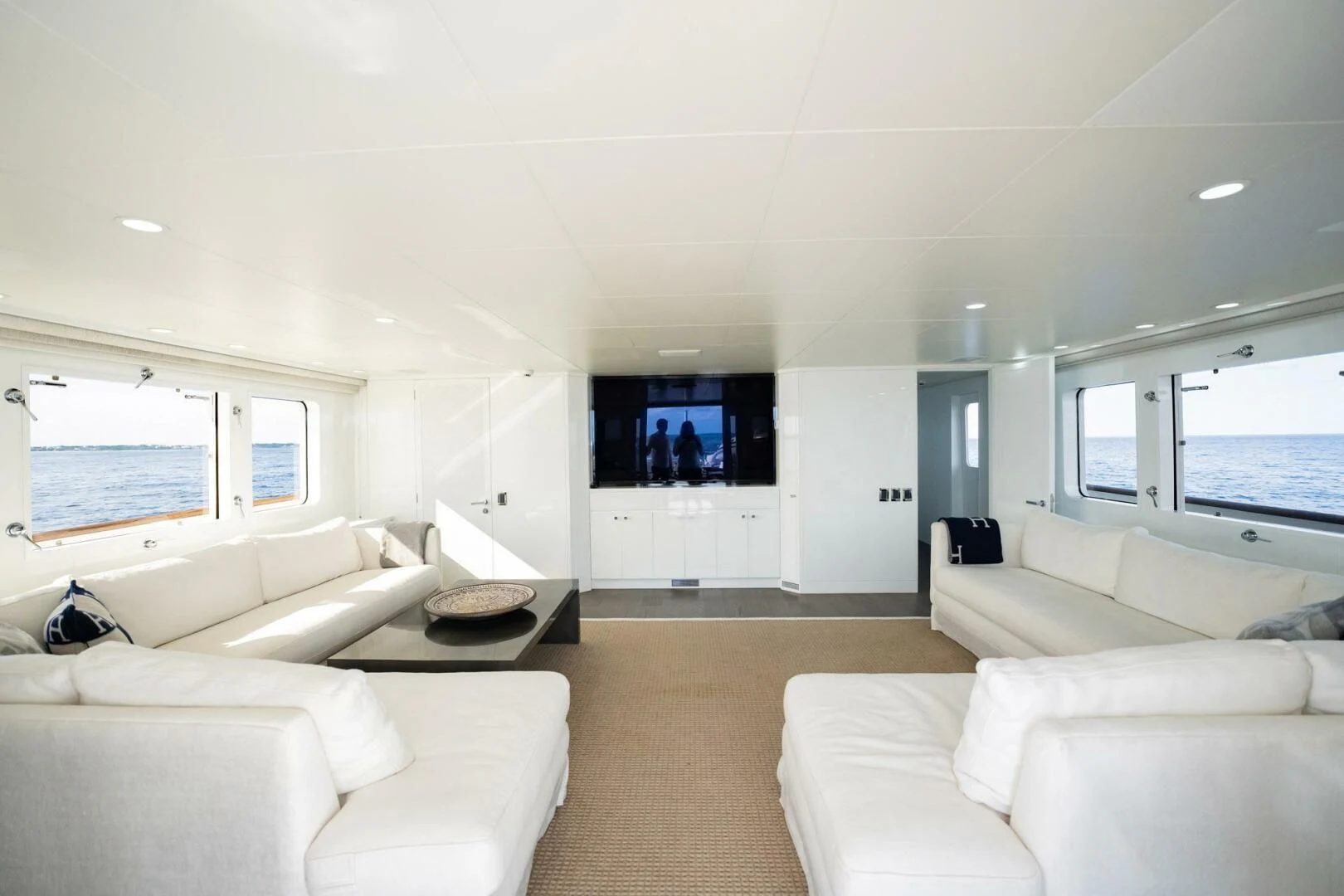 a living room with white couches aboard BG Yacht for Sale