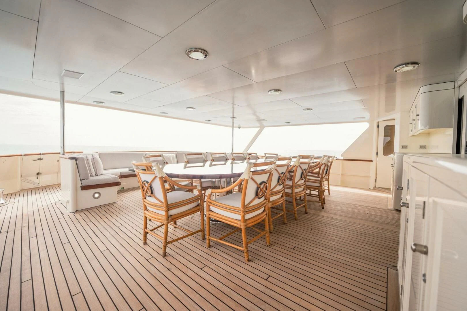 a room with a table and chairs aboard BG Yacht for Sale