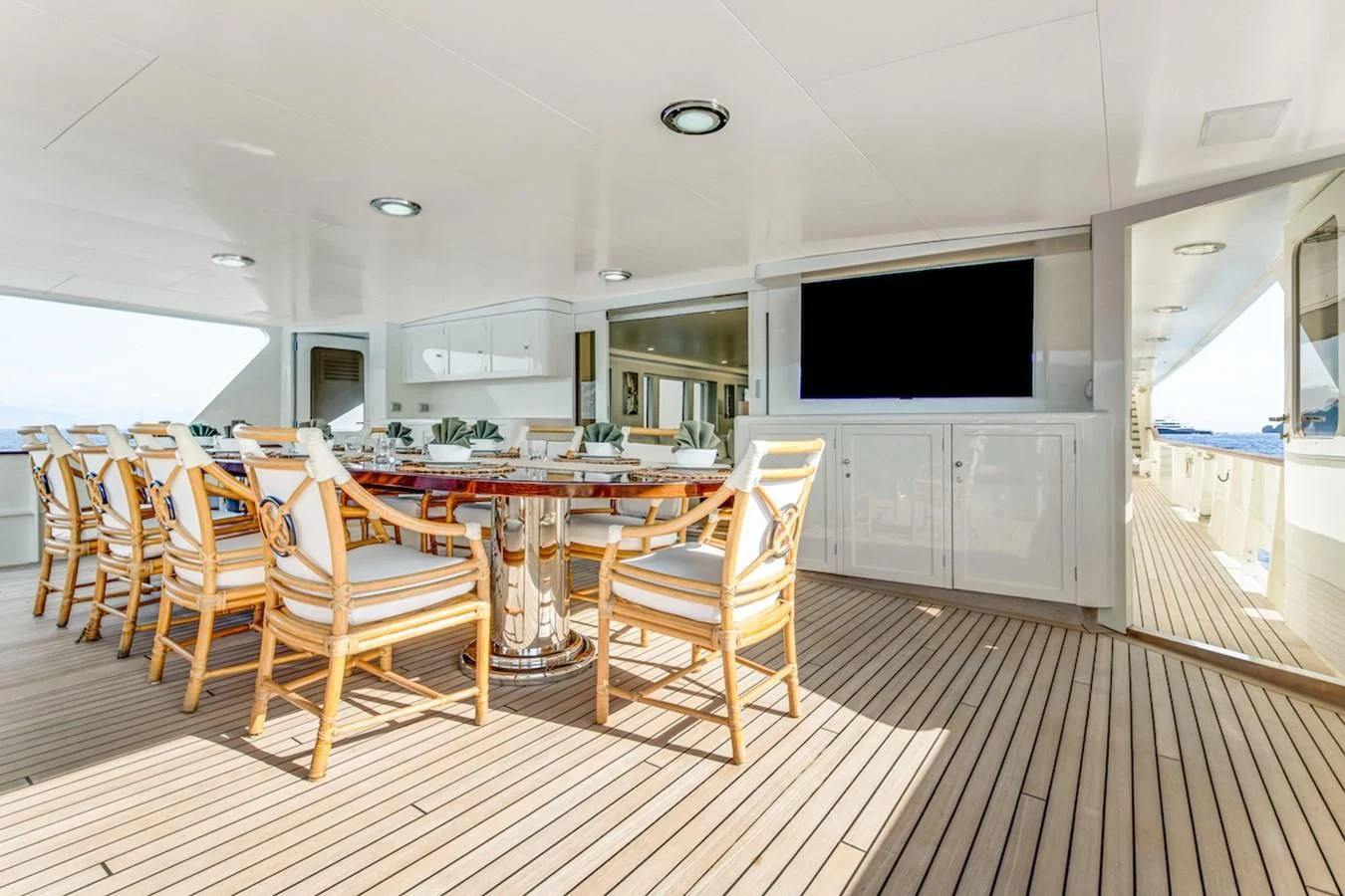 a room with chairs and a television aboard BG Yacht for Sale