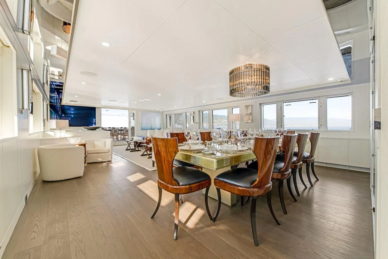 a large room with a table and chairs aboard BG Yacht for Sale