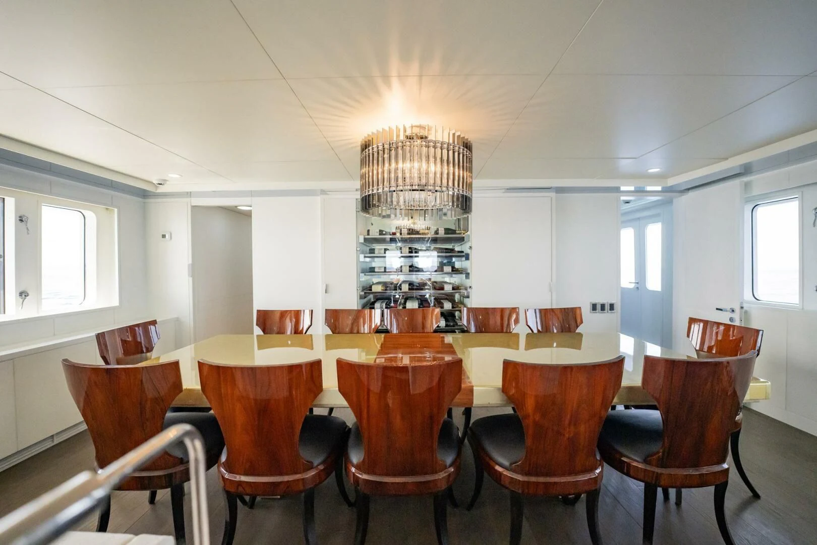 a large dining room with a chandelier aboard BG Yacht for Sale