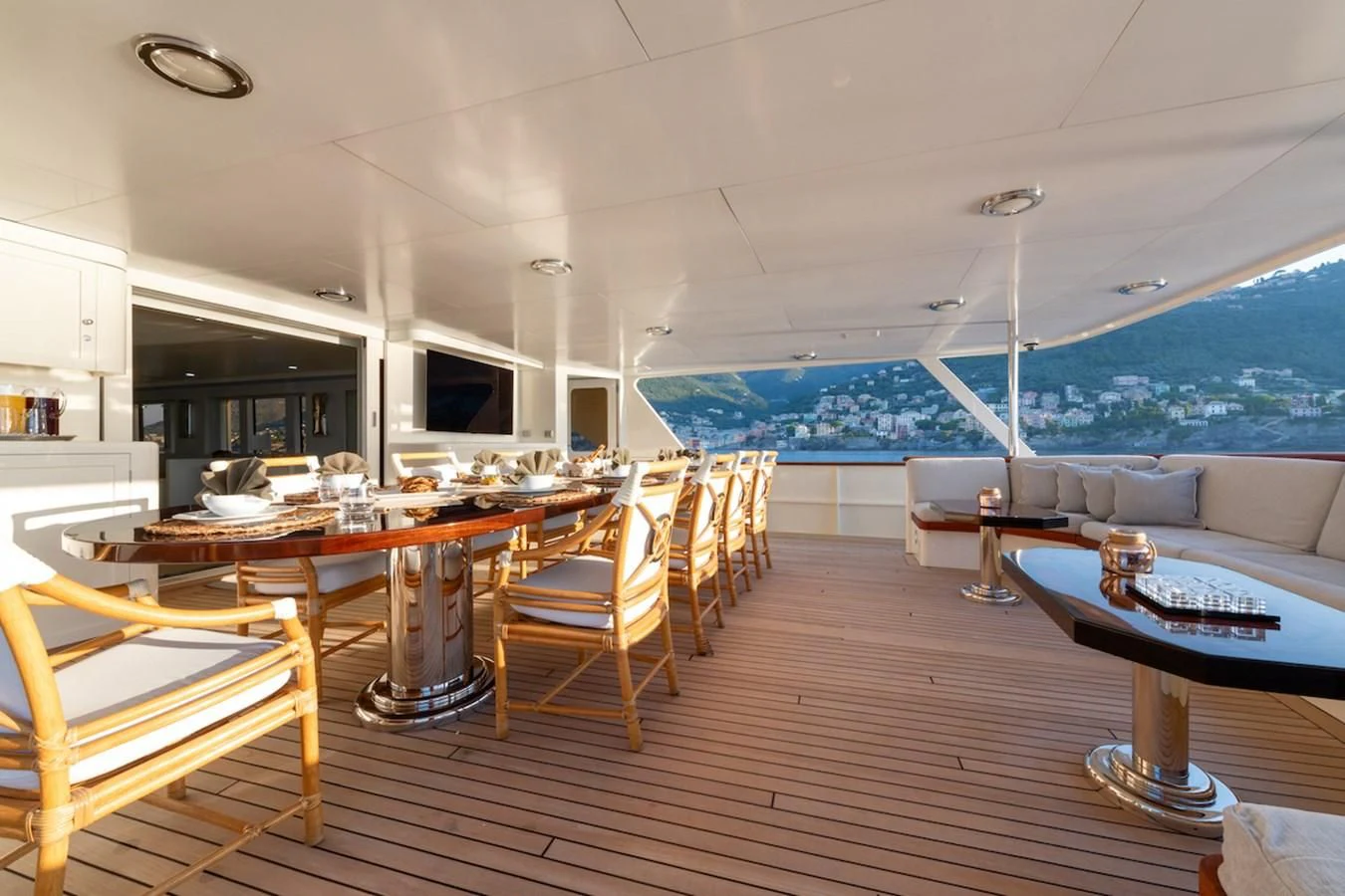 a room with a wood floor and a large window with a view of the ocean aboard BG Yacht for Sale