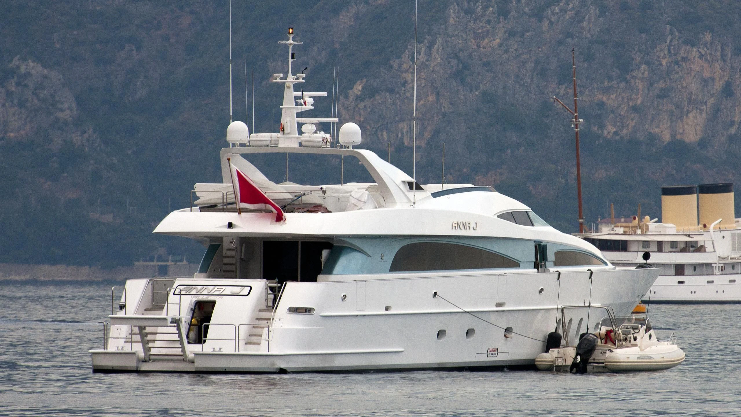 a white yacht in the water aboard STREGA Yacht for Sale
